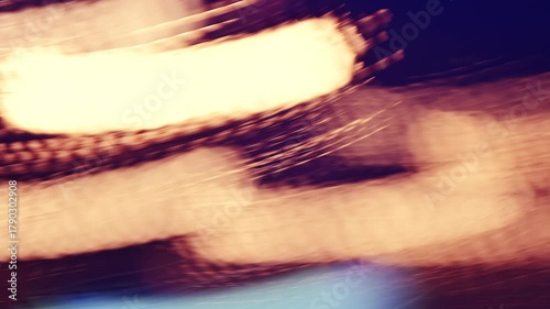 Slow shutter speed footage with motion blur and smeared colorful bokeh circles from street lights at night, abstract dreamy background. 4K