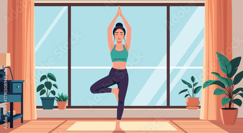 Woman practicing tree pose yoga on a mat in a brightly lit room with large windows and plants.