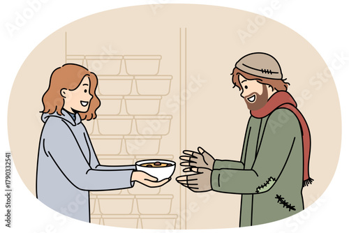 Woman volunteer feeds homeless man who came to shelter for help and hot meals, standing near shelves with plates. Volunteer girl demonstrates kindness and willingness to come to aid people in trouble