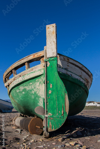 old abandoned wooden boat on the beach, an old shipwreck boat abandoned stand on beach or Shipwrecked off the coast of El Alquian, Almeria, Andalusia, Spain, old rusty wooden boat