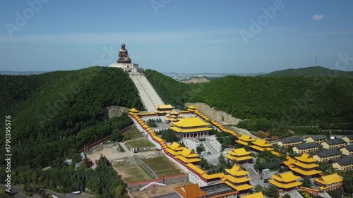 Aerial view of the Golden Buddha statue at Liudingshan Cultural Tourism Area in Dunhua City, Jilin Province, China. Massive golden statue overlooking Zhengjue Temple and facing the Changbai Mountain