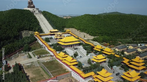 Aerial view of the Golden Buddha statue at Liudingshan Cultural Tourism Area in Dunhua City, Jilin Province, China. Massive golden statue overlooking Zhengjue Temple and facing the Changbai Mountain
