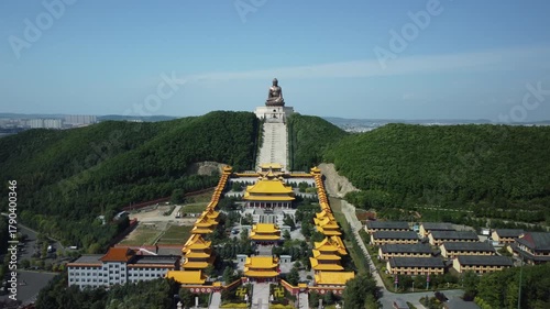 Aerial view of the Golden Buddha statue at Liudingshan Cultural Tourism Area in Dunhua City, Jilin Province, China. Massive golden statue overlooking Zhengjue Temple and facing the Changbai Mountain