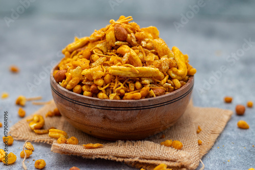 Bombay mix is a spicy, crunchy Indian snack blend of fried lentils, nuts, chickpea flour noodles, and aromatic spices.
