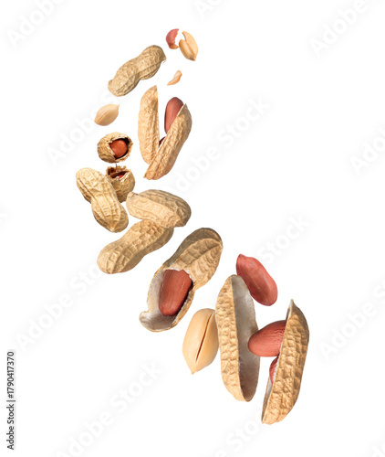 Whole and crushed dried peanuts flying in the air close-up isolated on a white background
