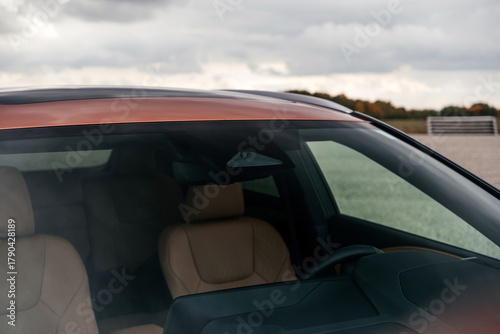 A premium, modern hybrid SUV with an elegant design, incredible color, beautiful wheels, and a large grille.