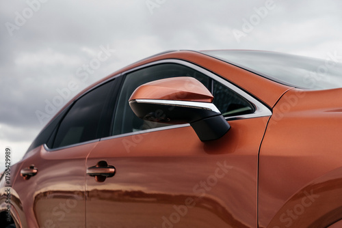 A premium, modern hybrid SUV with an elegant design, incredible color, beautiful wheels, and a large grille.