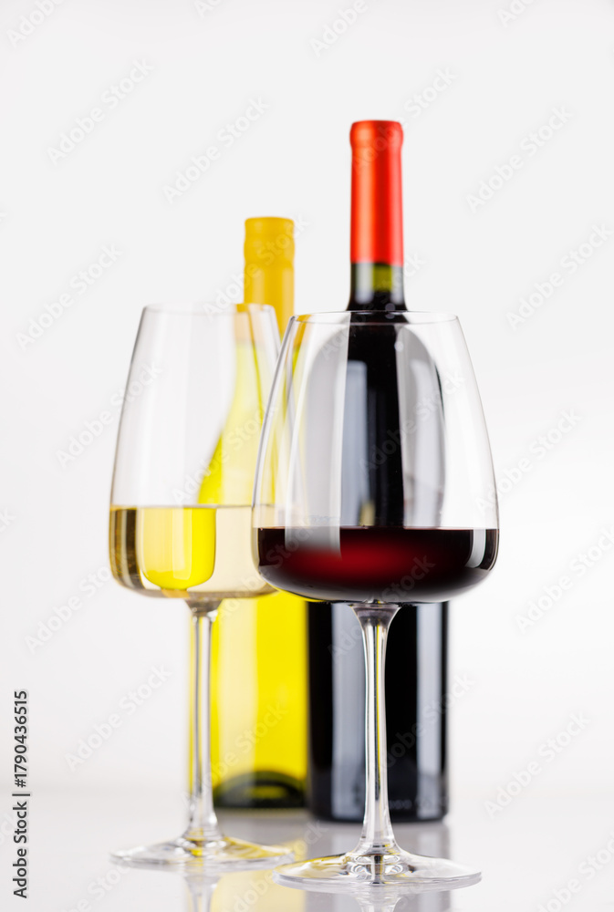 Naklejka premium Different wine bottles and glasses on white background