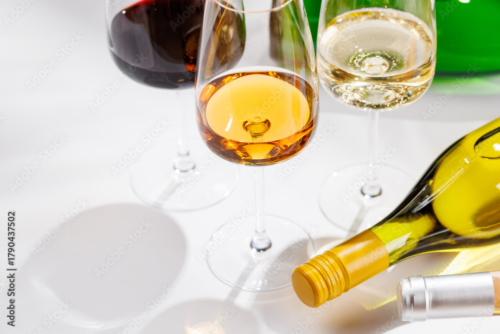 Naklejka premium Different wine bottles and glasses on white background