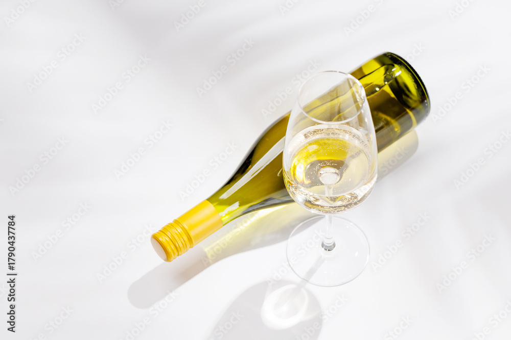 Naklejka premium White wine bottle and glass on white background