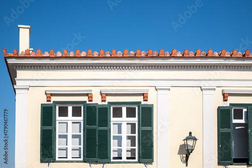 Traditional Building Facade with Green window Shutters