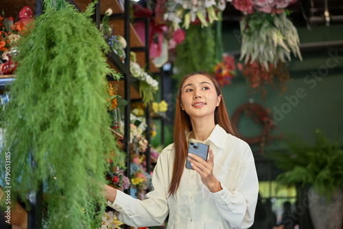 Owner small business managing flower stock with a smartphone