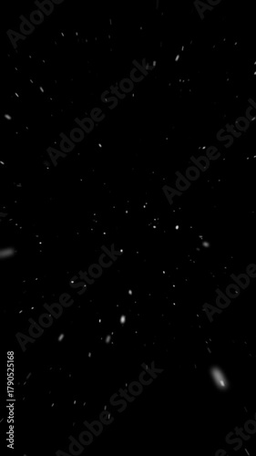 Realistic snowfall blowing toward the camera on black background, falling snow flake particle effects for christmas holiday celebration, overlay facing natural winter storm vertical backdrop

