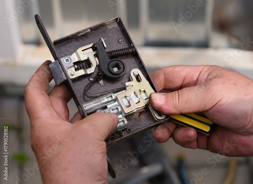 Person repairing a lock for a door