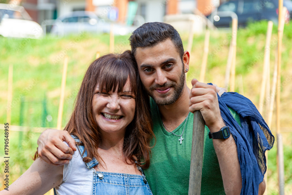 Fototapeta premium Couple working and spending time together in a garden, actively embracing