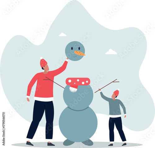 Father and son making a snowman. Winter fun for the family.