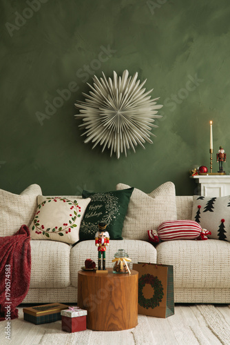 Warm holiday living room with a white sofa, wooden table, Christmas cushions, and nutcracker decorations against a green wall.