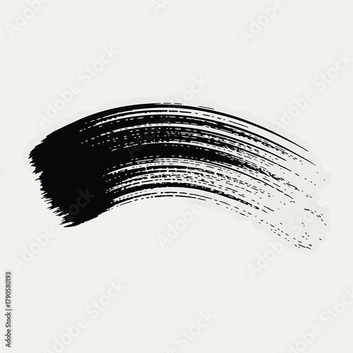 Black ink brush stroke with textured lines on a light background