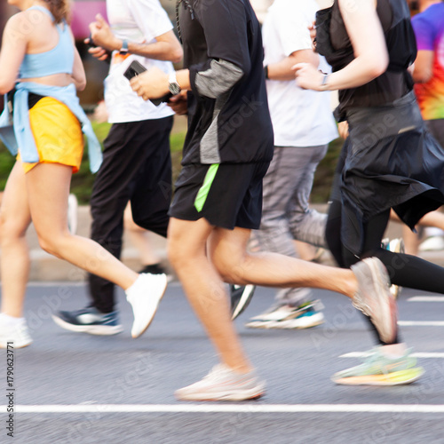 team of several athletes jogging quickly down the street