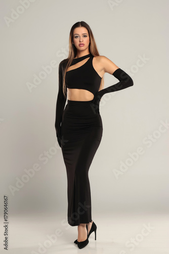 Konstfotografi Full length studio shot of a tall brunette woman wearing an elegant black asymme