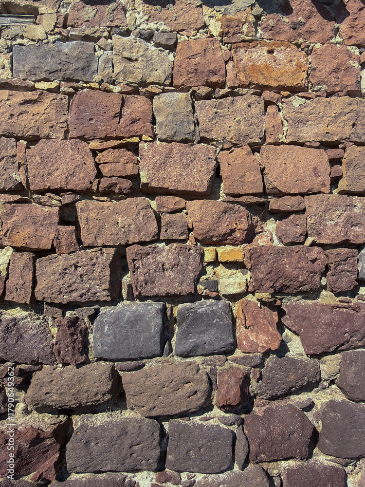 Obraz premium Rustic Stone Wall Texture with Mixed Volcanic Rocks