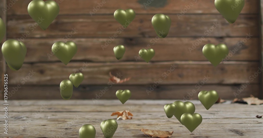 Naklejka premium Floating olive-green heart-shaped metallic balloons with plank wall, wooden floor, dry leaves