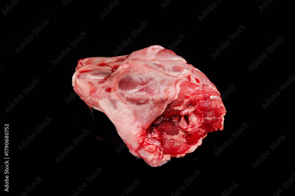 Obraz premium Fresh Raw Rabbit Head Meat Cut on Black Background - Butcher Shop Ingredient