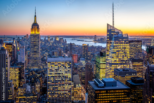 Aerial view of the iconic Manhattan in New York, USA at night with its famous skyscrapers and lights.