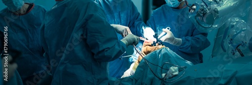 Surgeons in a sterile operating room are performing knee replacement surgery with the robotical surgery knee system, utilizing robotic assistance for precise bone resection