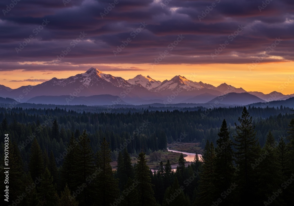 Obraz premium Mountains glow during sunset over evergreen forest landscape