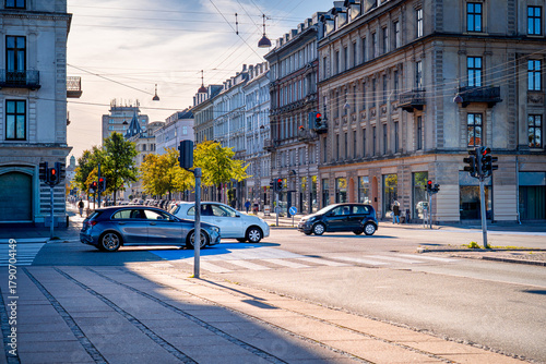 Photography Traffic at Copenhagen intersection with cars, and cyclists in the morning, Denmark