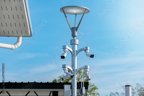 Obraz na plátně Pixed ip cctv cameras installed on outdoor high metal post of the buildings to do security by monitoring on mobile phone and computer to save human life and property by cctv cameras instead of human