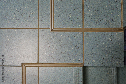 Blue tiled floor with visible expansion joints and metal edge profiles