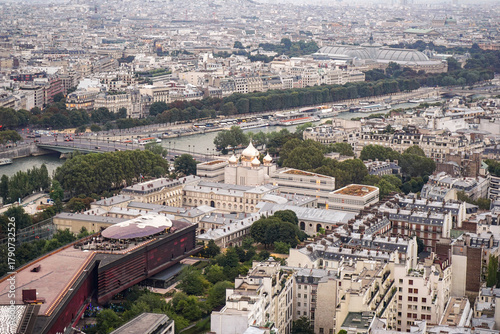 Fototapeta Naklejka Na Ścianę i Meble -  An aerial view of a part of the city of Paris, showing an Orthodox Christian church The church has golden domes, and the streets and the river are visible