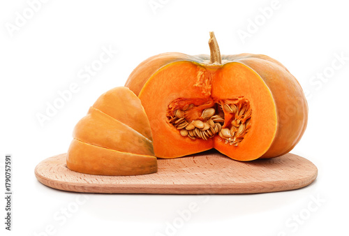 Sliced pumpkin with seeds on wooden board isolated on white background.