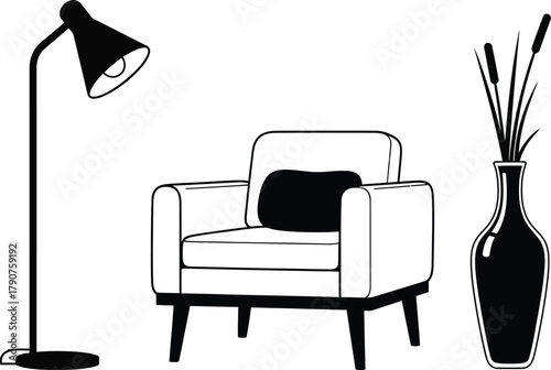 A modern armchair with a floor lamp and a vase of reeds.