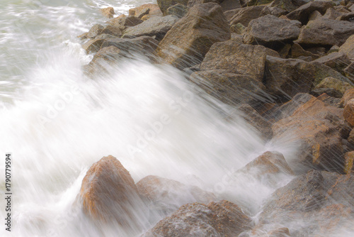 Ocean waves crashing against rocks on the shore
