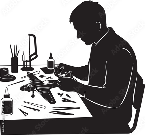 Hobbyist meticulously assembling a model airplane at a well-equipped workbench side view silhouette