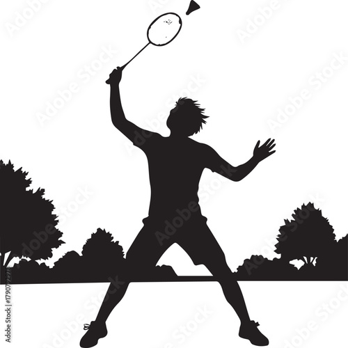 Active silhouette of badminton player serving shuttlecock during outdoor match