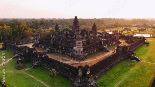 Aerial view of the angkor wat temple complex in siem reap, cambodia. Golden sunrise light illuminates the ancient khmer architecture and surrounding jungle. UNESCO World Heritage Site