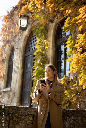 Woman enjoying autumn leave...