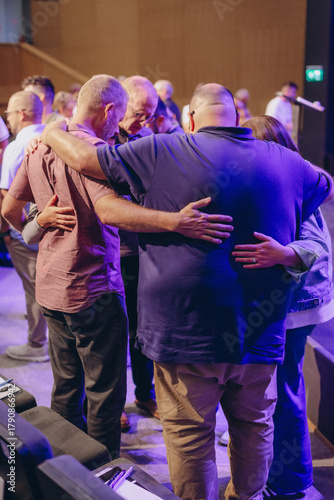 A Group of Christians pray to bless and pray for each other in church
