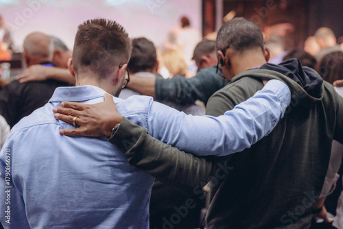 A Group of Christians pray to bless and pray for each other in church