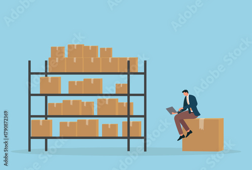 Vector illustration of a businessman sitting on a box and working on a laptop beside warehouse shelves filled with packages, representing inventory management, logistics, e commerce