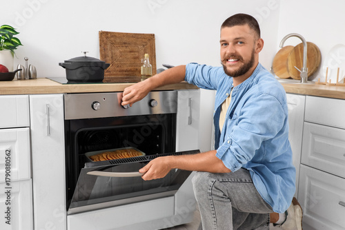 Young man adjusting electri...