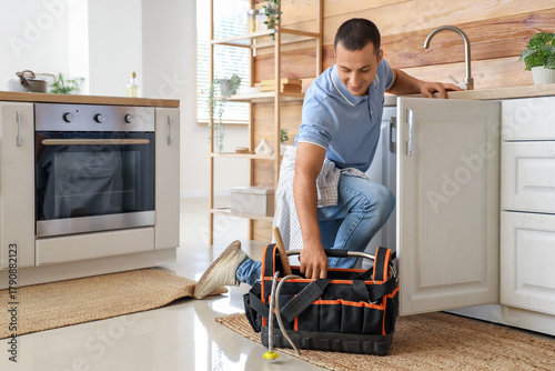 Male plumber with bag of to...