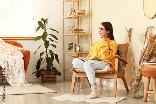 Thoughtful young woman sitt...