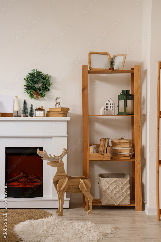 Fototapeta premium Modern fireplace with Christmas decorations in interior of living room