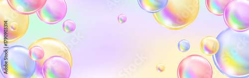 Multicolored spheres and pink bubbles sparkling on a radiant rainbow background.