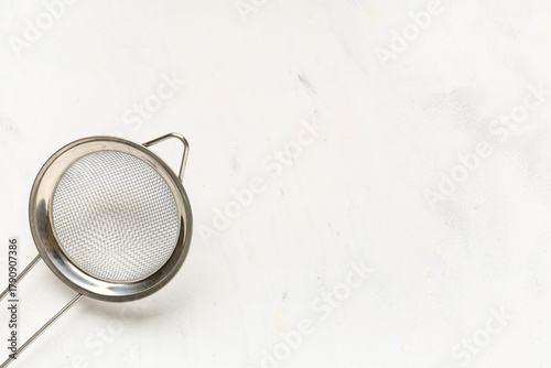 Metal sieve on white grunge...